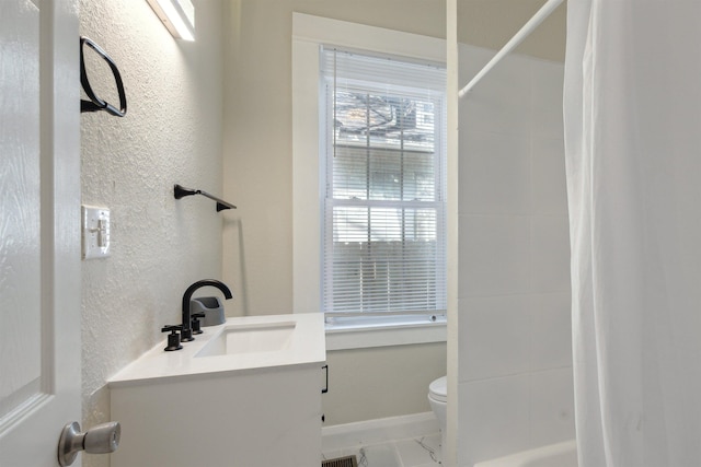 bathroom with vanity and toilet