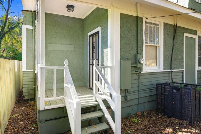 doorway to property featuring central air condition unit