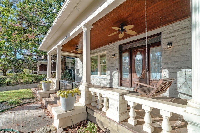 entrance to property with ceiling fan and covered porch