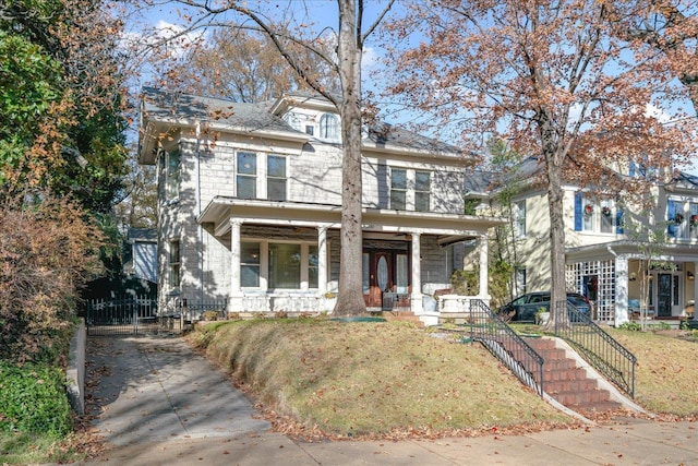 front facade with a front lawn and covered porch