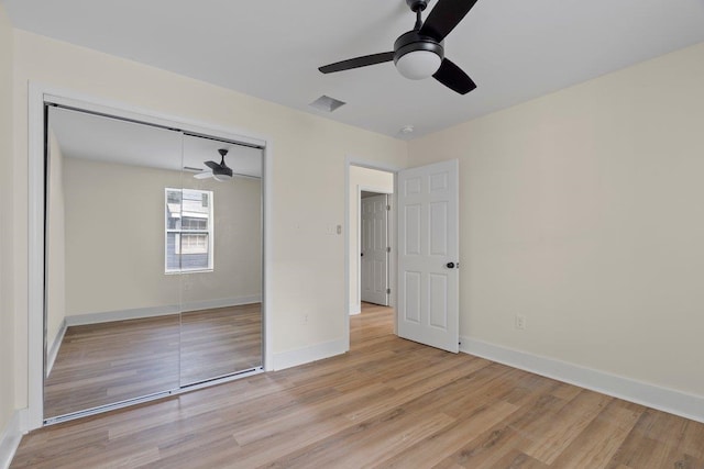 unfurnished bedroom featuring ceiling fan, light hardwood / wood-style flooring, and a closet