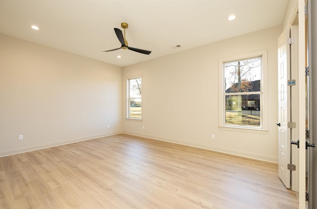 unfurnished room featuring ceiling fan, light wood-type flooring, and plenty of natural light