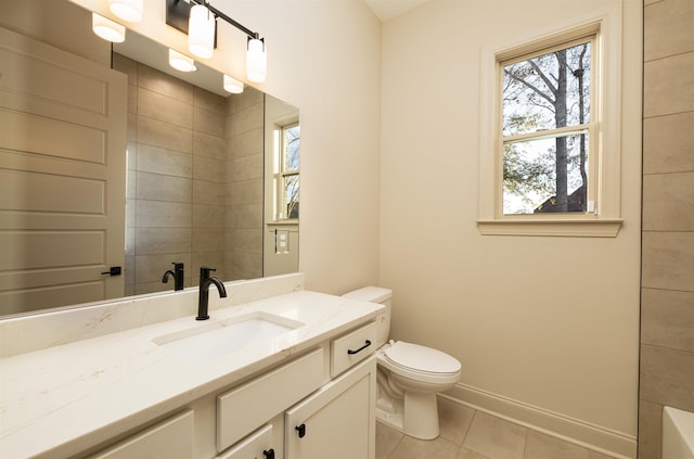 bathroom featuring a washtub, tile patterned flooring, vanity, and toilet