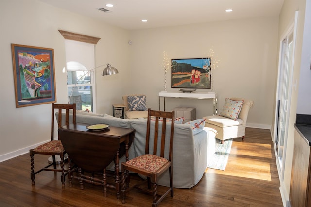 sitting room with dark wood-type flooring