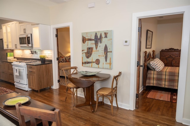 dining room with dark hardwood / wood-style floors