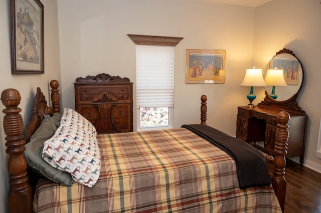 bedroom with dark hardwood / wood-style floors