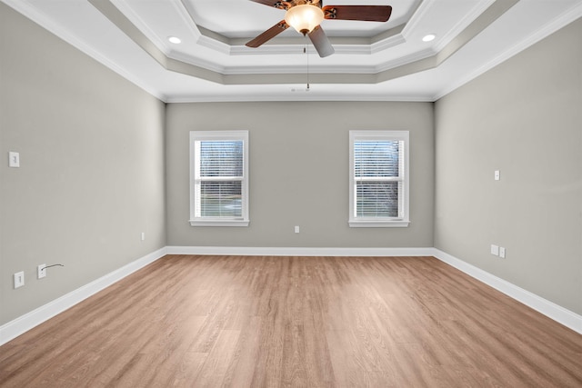 empty room featuring ornamental molding, a wealth of natural light, and light hardwood / wood-style flooring