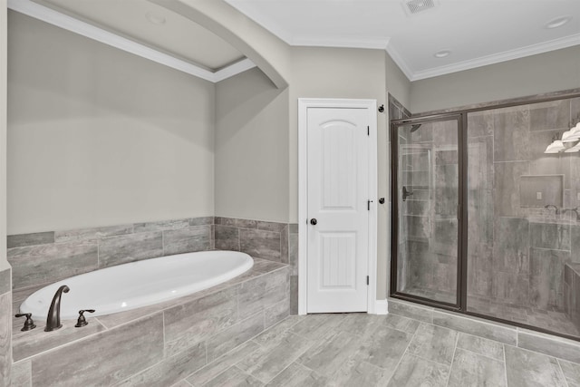 bathroom featuring crown molding and independent shower and bath