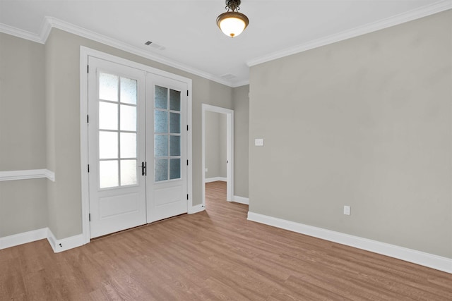 doorway to outside with crown molding, light hardwood / wood-style flooring, and french doors