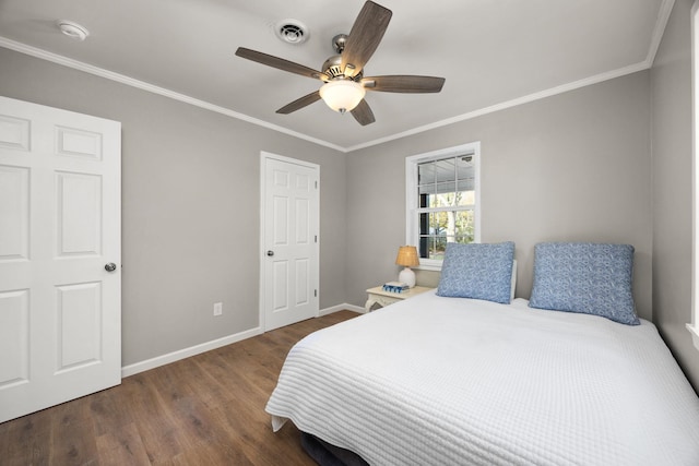 bedroom with dark hardwood / wood-style floors, ceiling fan, and crown molding