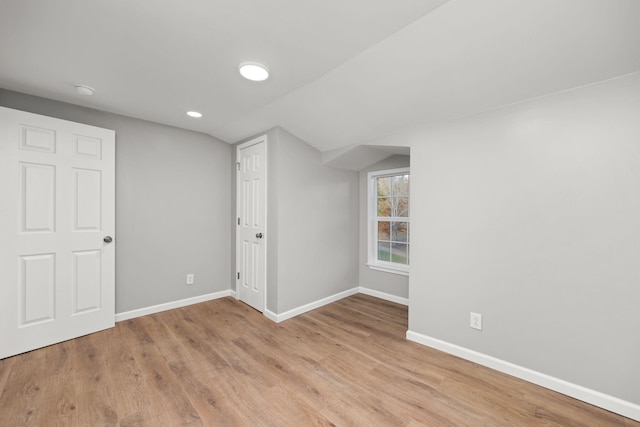 bonus room featuring light wood-type flooring and lofted ceiling