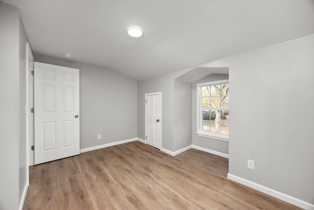 bonus room featuring vaulted ceiling and hardwood / wood-style flooring