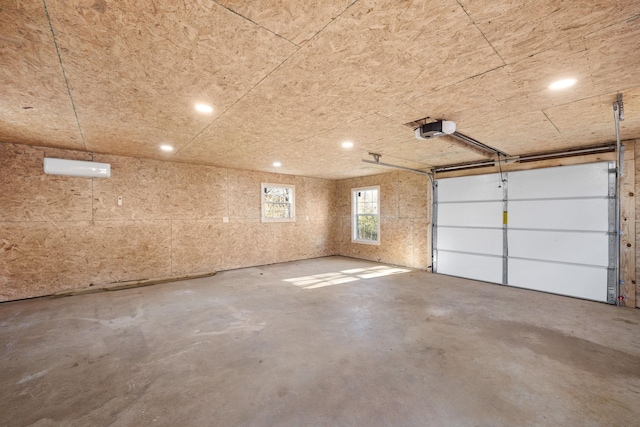 garage featuring a garage door opener and a wall unit AC