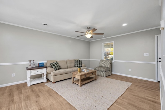 living room with hardwood / wood-style floors, ceiling fan, and ornamental molding