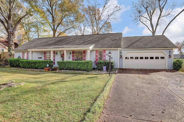 single story home featuring a garage and a front lawn