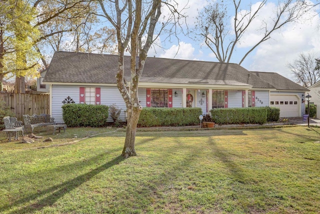 ranch-style house featuring a garage and a front lawn