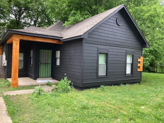 rear view of property with a lawn