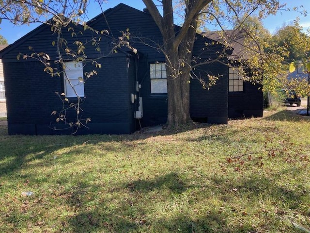 view of side of property with a yard