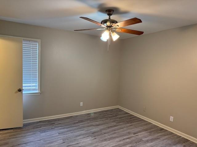 spare room featuring ceiling fan and dark wood-type flooring