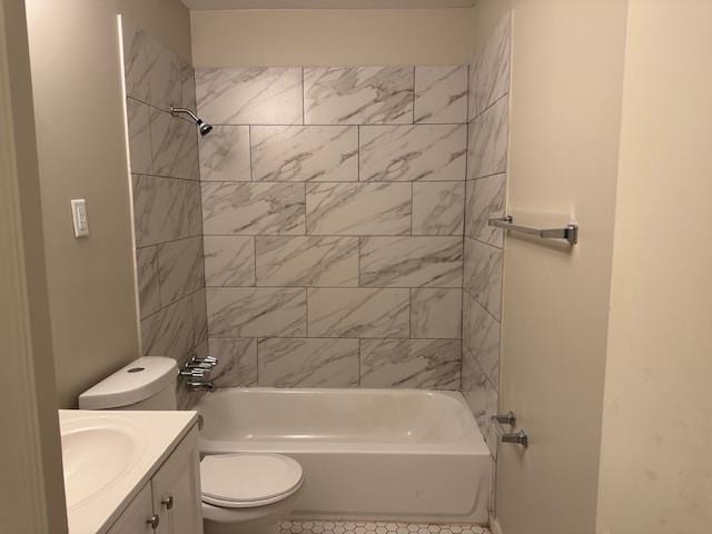 full bathroom with tile patterned floors, vanity, tiled shower / bath combo, and toilet