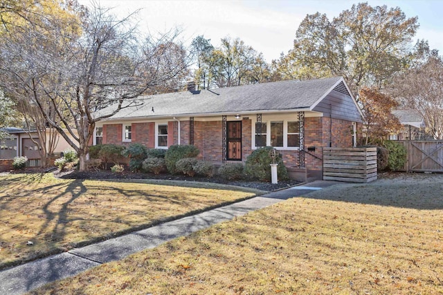 single story home featuring a front lawn