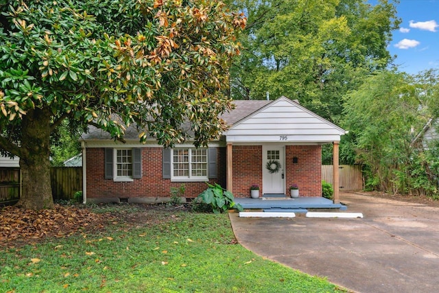 view of front of property with covered porch and a front yard