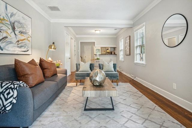 living room featuring light wood-type flooring and ornamental molding