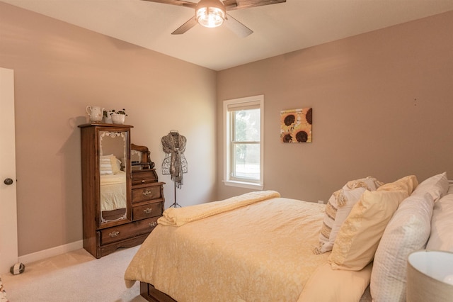 bedroom with ceiling fan and light carpet