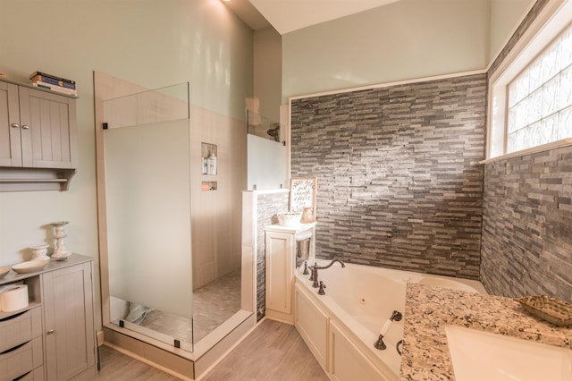 bathroom with wood-type flooring, vanity, and separate shower and tub