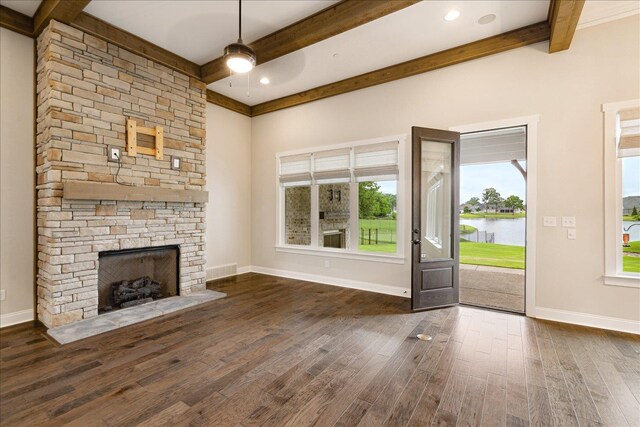 680 Magnolia Ln, Piperton, TN 38017 - unfurnished living room with wood finished floors, ceiling fan, beamed ceiling, a water view, and a stone fireplace