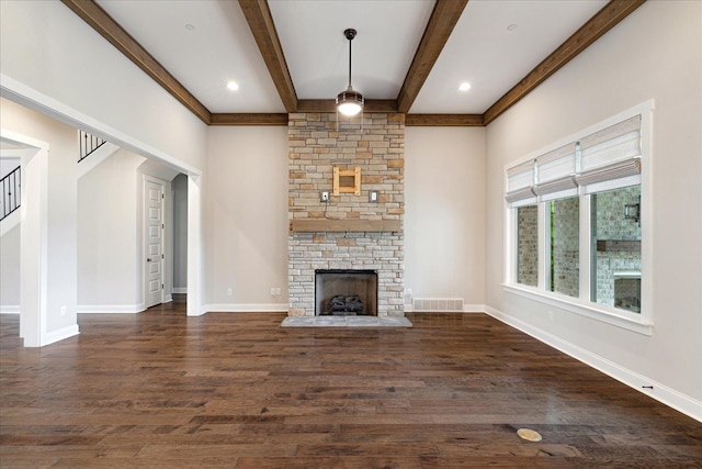 680 Magnolia Ln, Piperton, TN 38017 - unfurnished living room with beamed ceiling, wood finished floors, a stone fireplace, and stairway