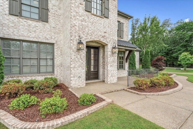 680 Magnolia Ln, Piperton, TN 38017 - view of exterior entry with brick siding and a metal roof