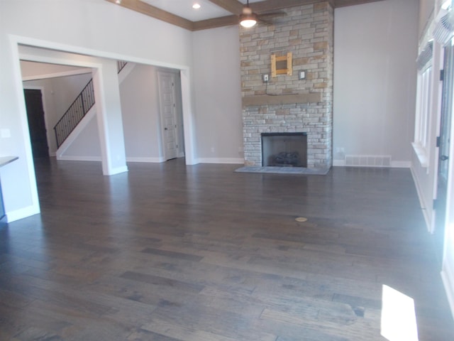 680 Magnolia Ln, Piperton, TN 38017 - unfurnished living room with stairway, a stone fireplace, dark wood-style flooring, and beamed ceiling