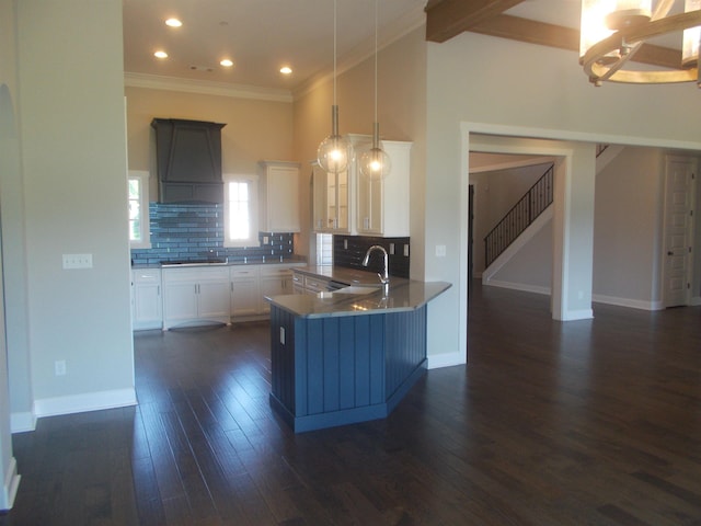 680 Magnolia Ln, Piperton, TN 38017 - kitchen featuring custom range hood, dark wood-type flooring, cooktop, backsplash, and crown molding