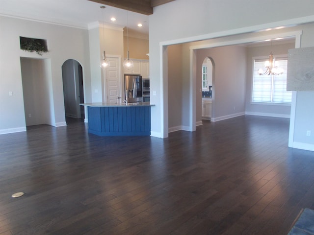 680 Magnolia Ln, Piperton, TN 38017 - unfurnished living room featuring arched walkways, a chandelier, dark wood finished floors, crown molding, and recessed lighting