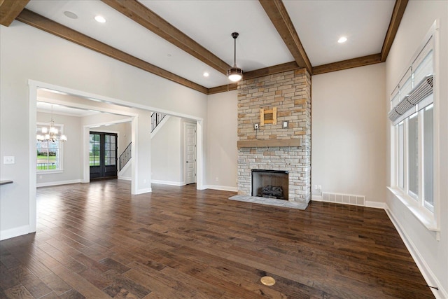 680 Magnolia Ln, Piperton, TN 38017 - unfurnished living room featuring a fireplace, beamed ceiling, dark wood-type flooring, a chandelier, and stairs