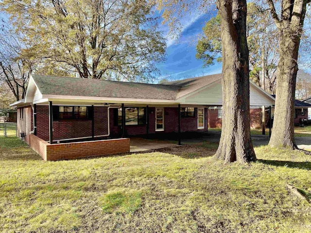 ranch-style home featuring a front yard and a carport