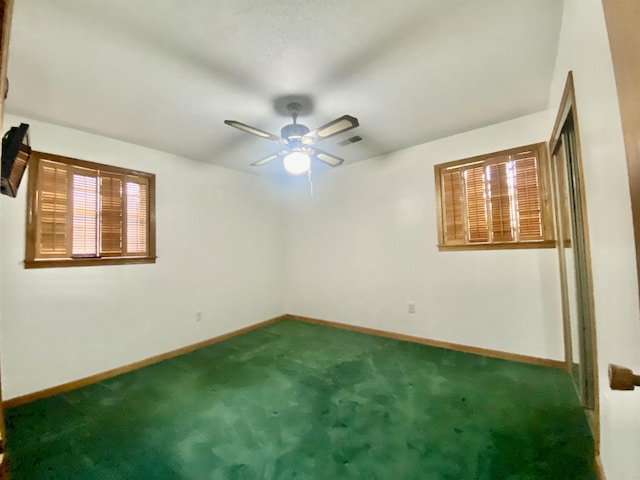 spare room with ceiling fan and carpet floors