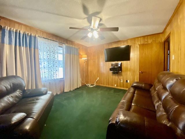 carpeted living room featuring ceiling fan, a textured ceiling, and wooden walls