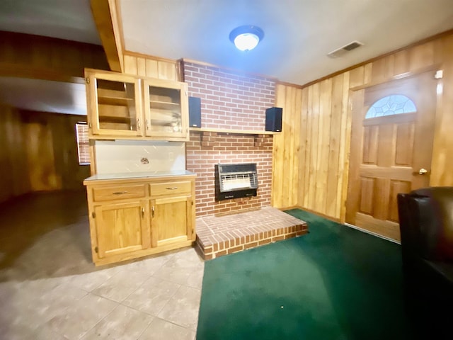 living room featuring a fireplace, light tile patterned floors, heating unit, and wood walls