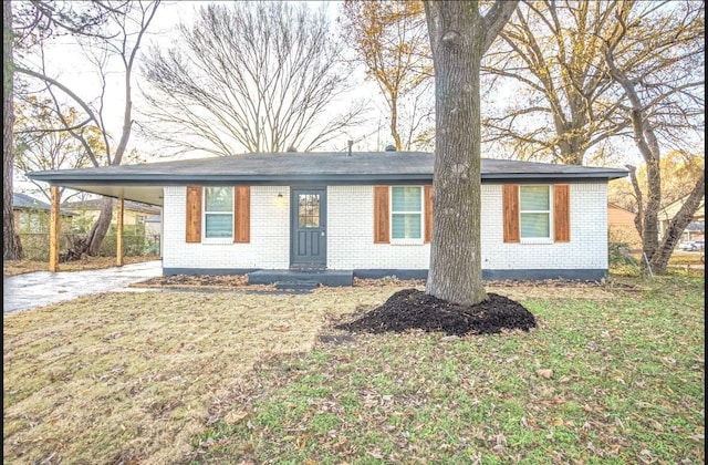 ranch-style home with a front lawn and a carport