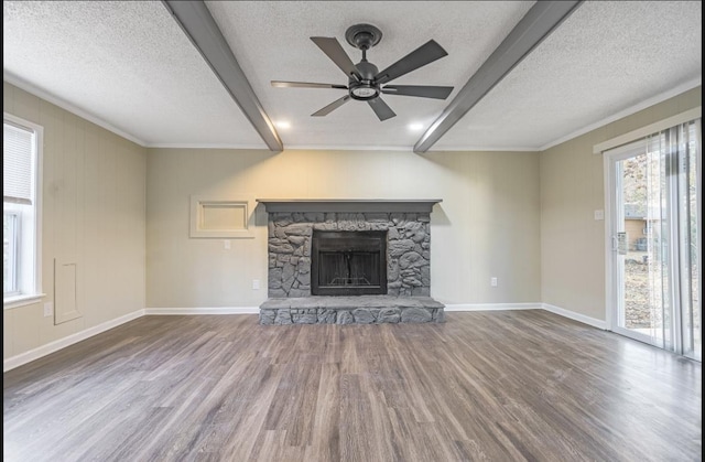 unfurnished living room featuring a textured ceiling, hardwood / wood-style flooring, a stone fireplace, and ceiling fan