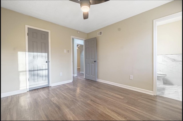 empty room with ceiling fan and dark hardwood / wood-style floors