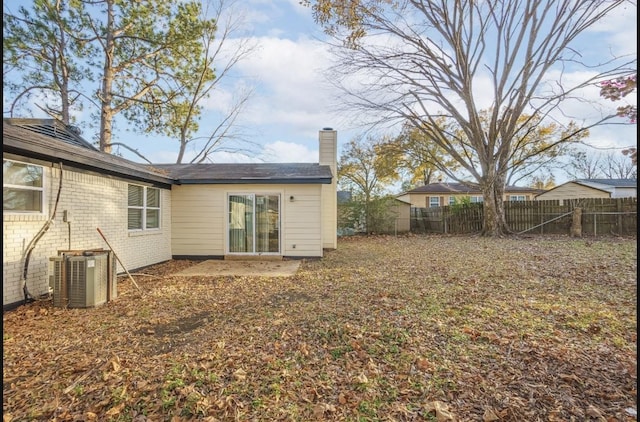 rear view of house featuring central AC unit