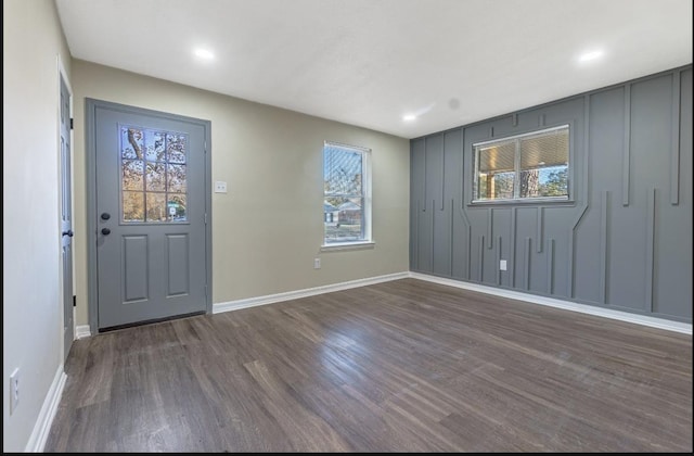 entryway with dark hardwood / wood-style flooring