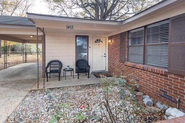 view of exterior entry with a carport