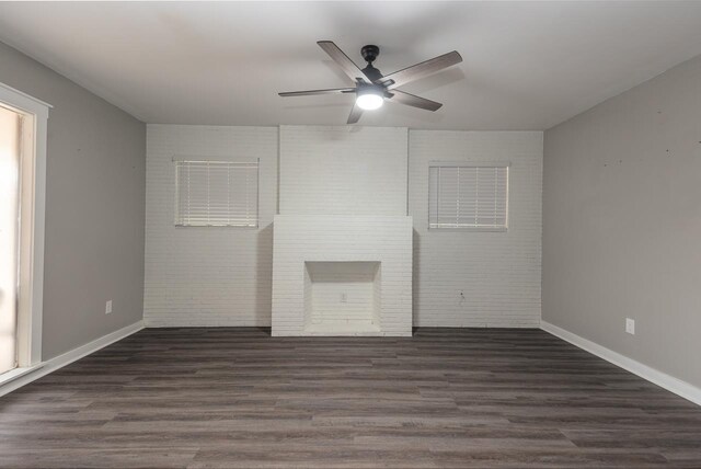 interior space with a fireplace, dark hardwood / wood-style floors, and ceiling fan