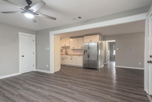 kitchen with white cabinetry, ceiling fan, tasteful backsplash, stainless steel fridge with ice dispenser, and dark hardwood / wood-style floors