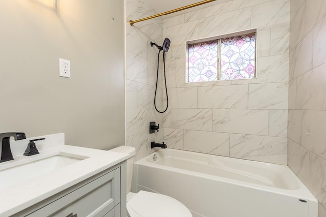 full bathroom with toilet, vanity, and tiled shower / bath