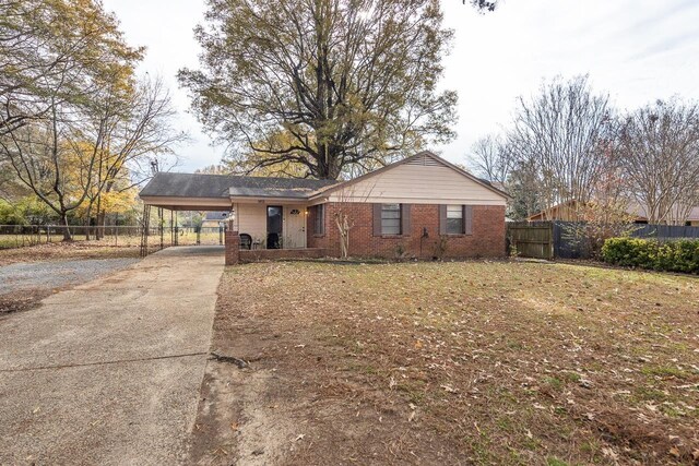 ranch-style home featuring a carport